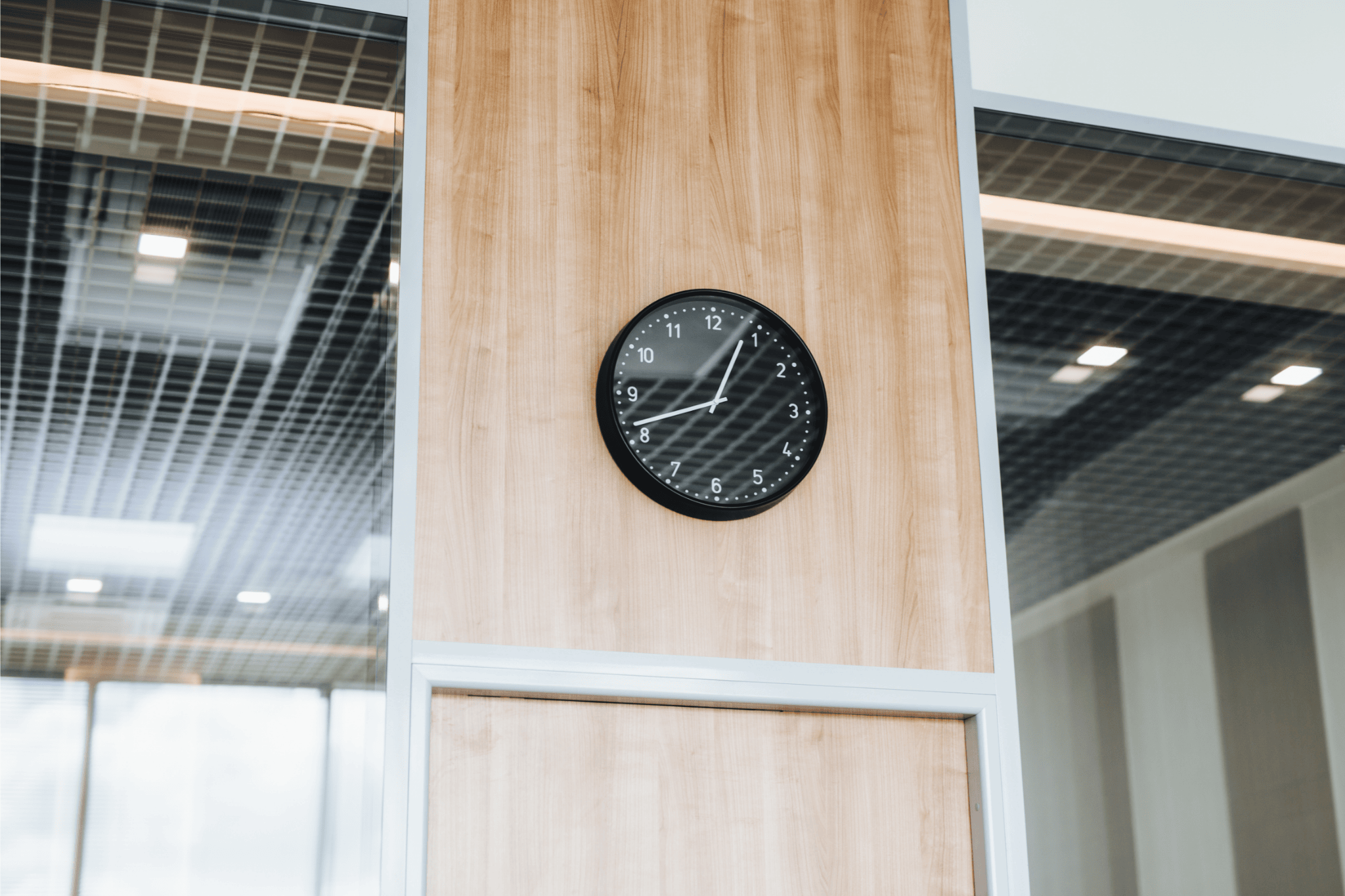 Photo of a black clock on an exam hall wall